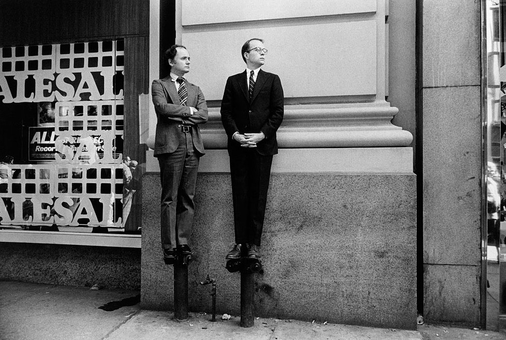Two Men on Stand Pipes Watching Parade, 1975.png